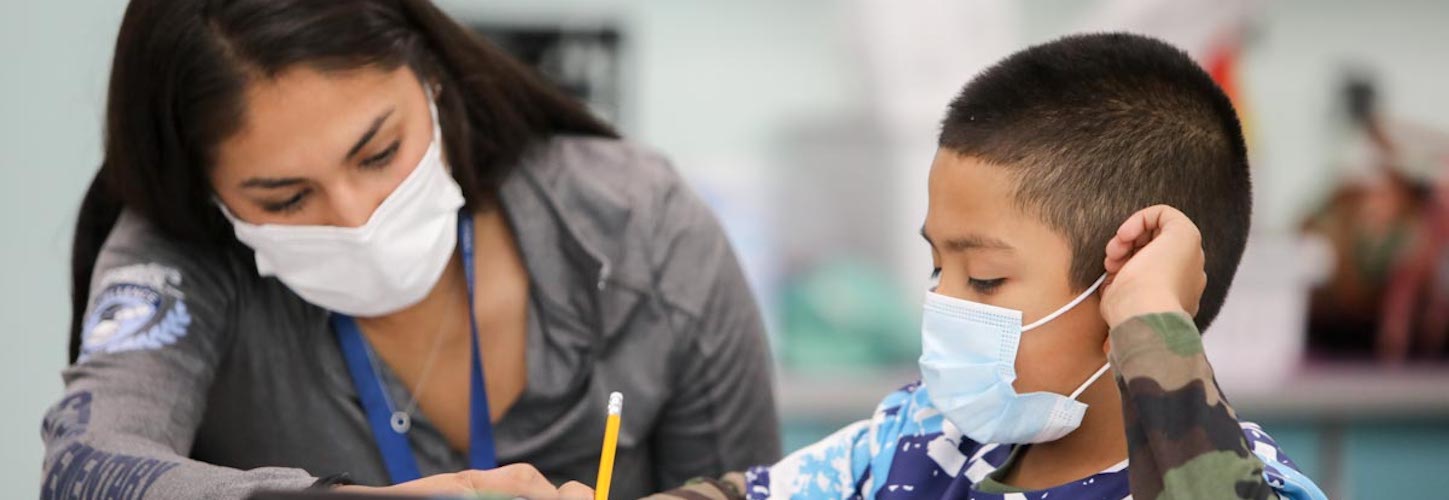 Teacher helping a student in class