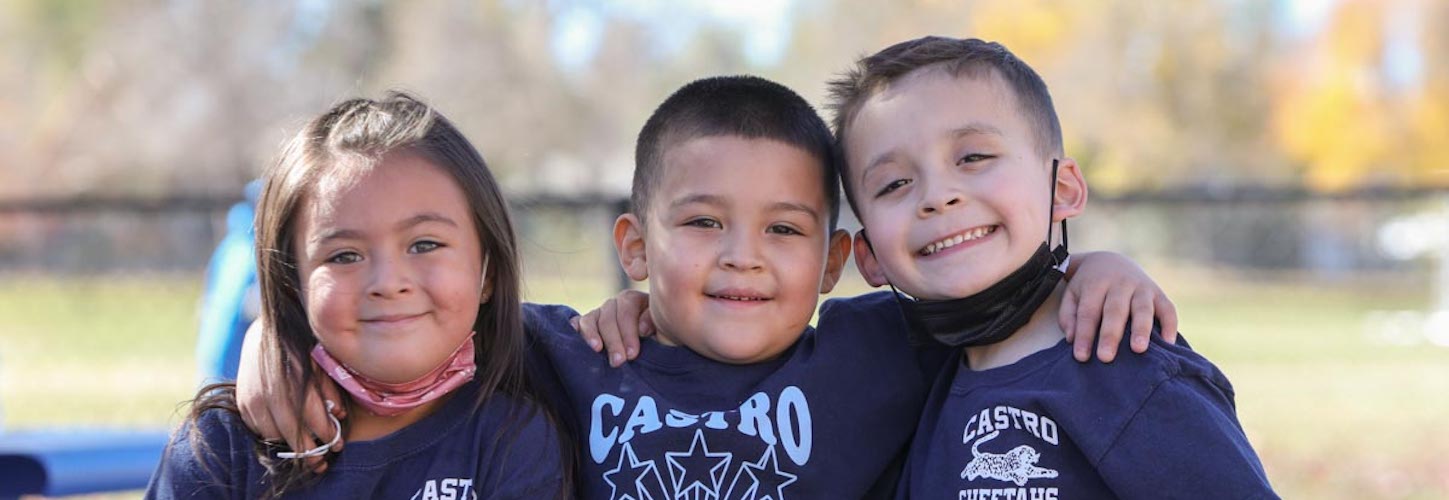 Three students posing outside